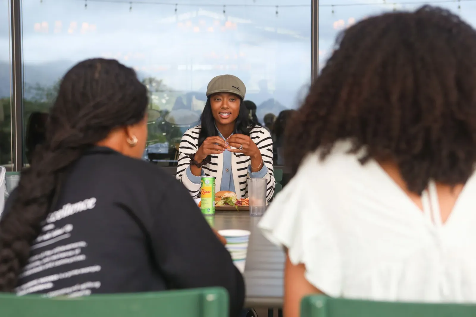 Blake Bolden talking with students around a lunch table